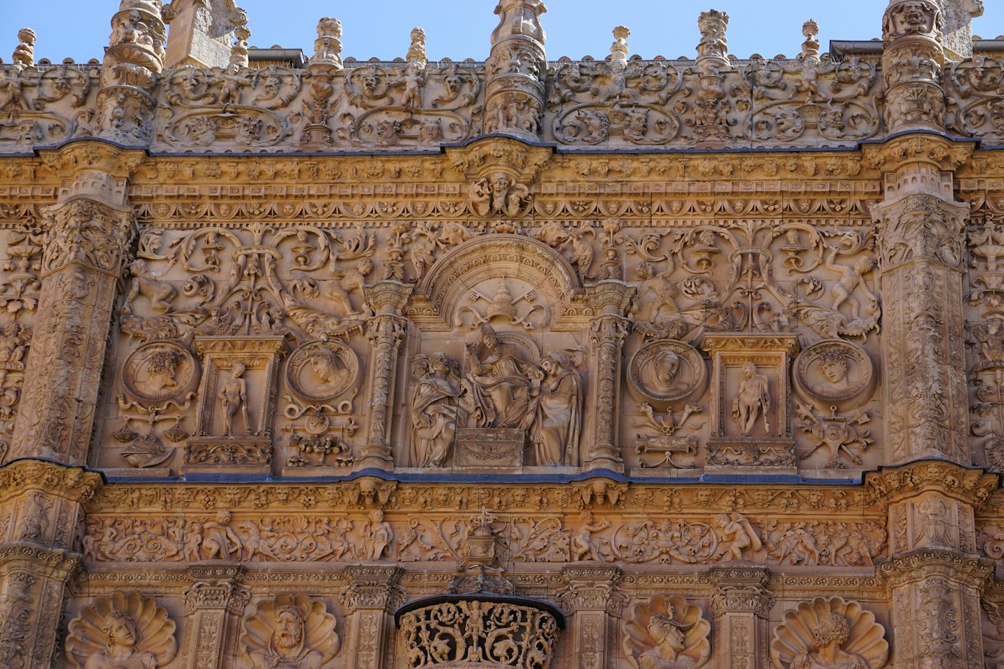 Facciata di un antico palazzo in pietra con intagli elaborati.
